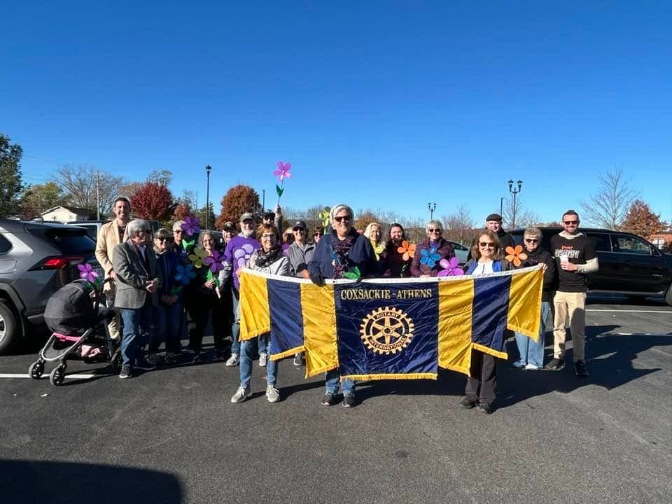 Club members gathered behind the Coxsackie-Athens Rotary banner on a clear autumn morning before the Walk to End Alzheimer’s.